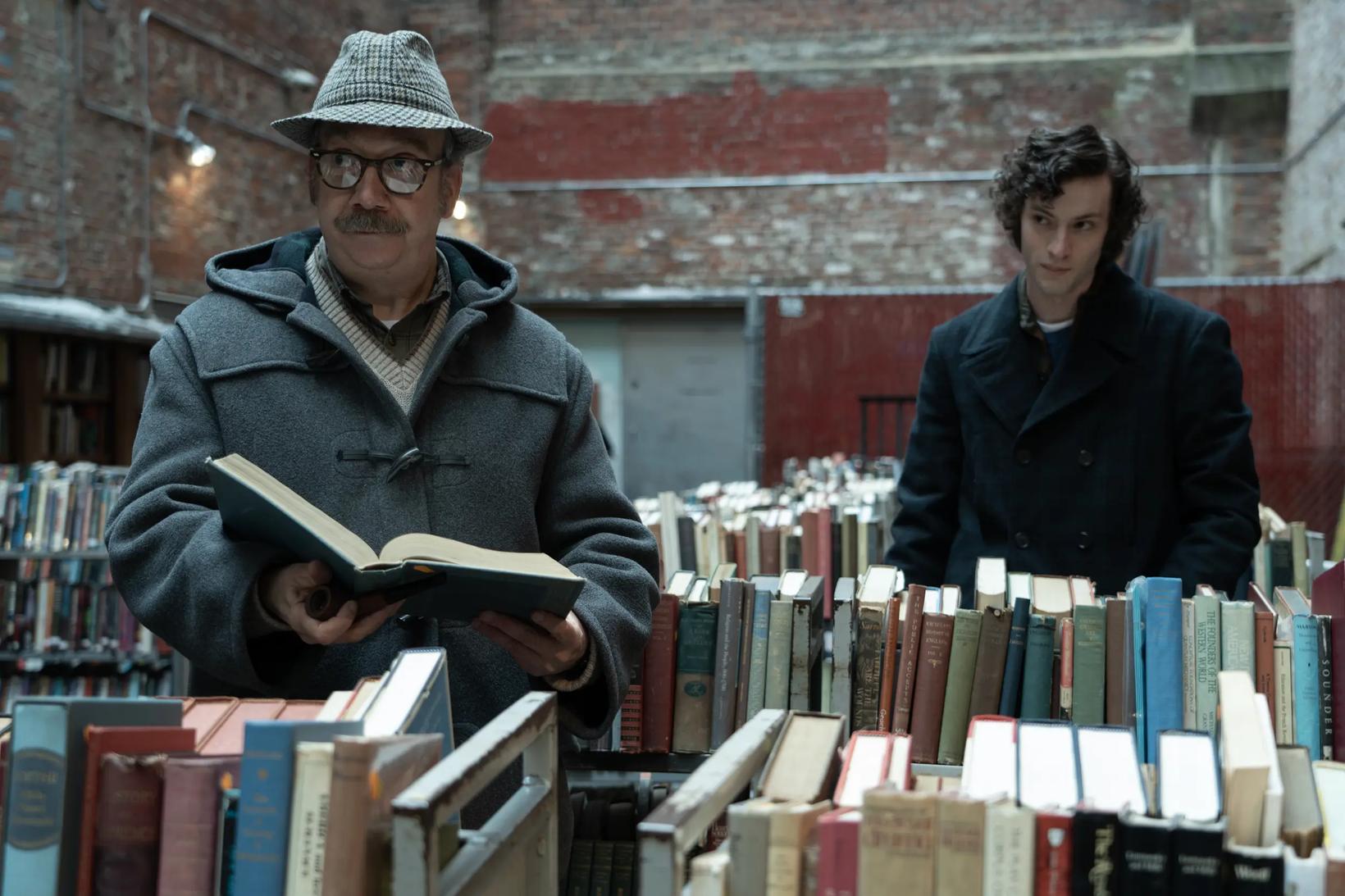 a man and a woman standing next to a shelf of books