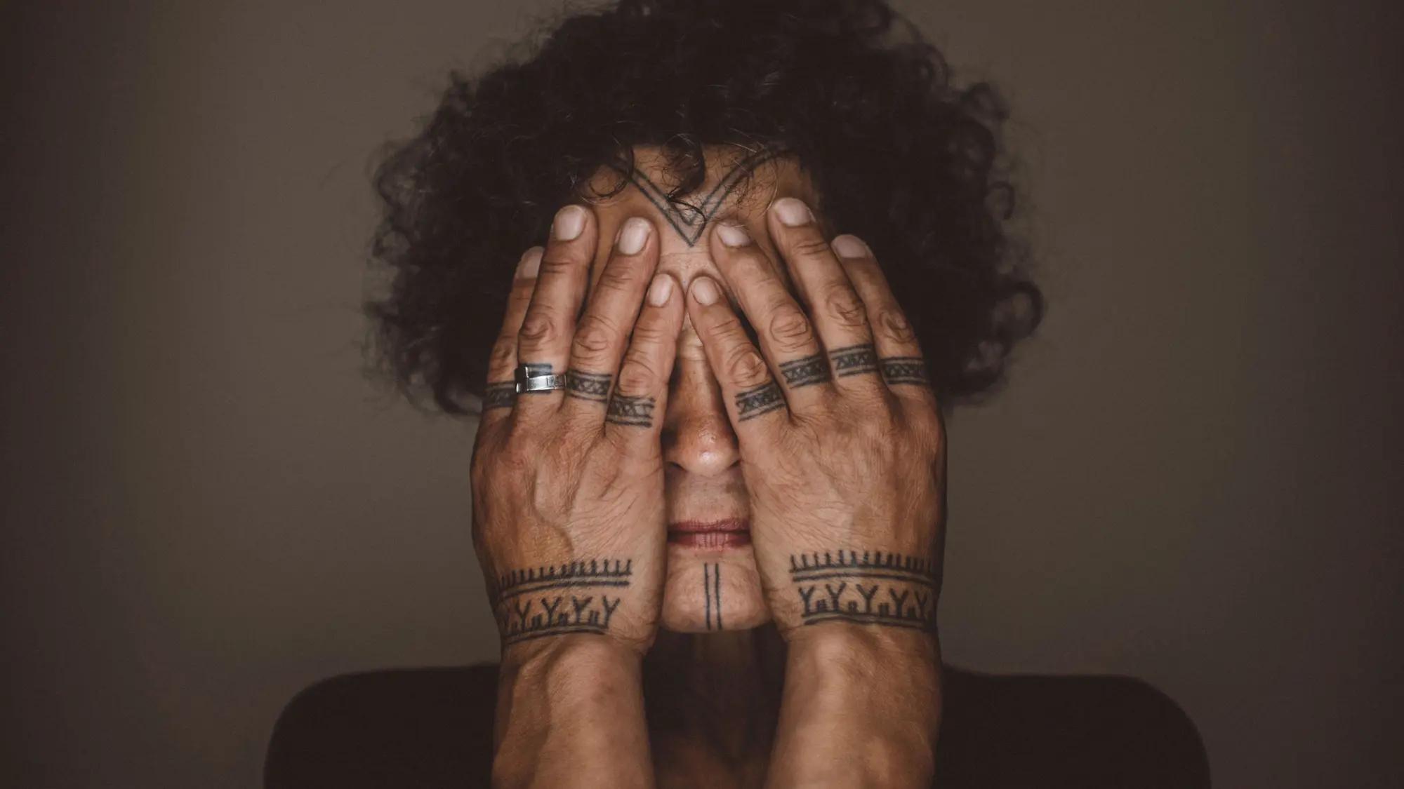 a person with tattoos on their hands
