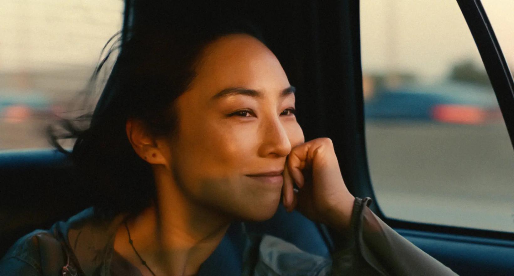 Greta Lee in a car