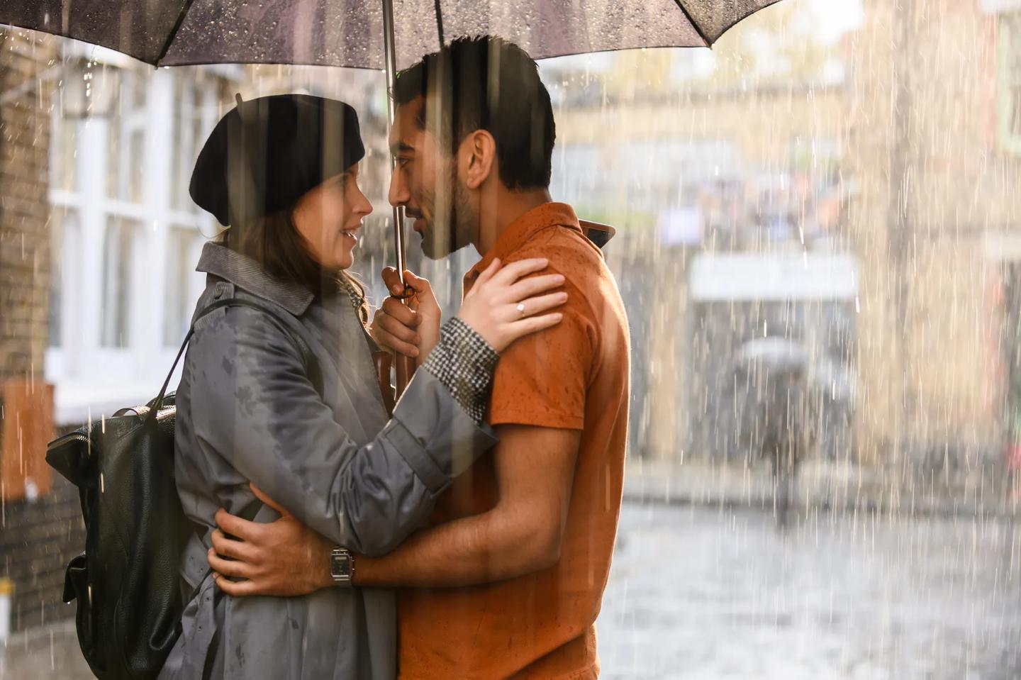 a man and woman holding an umbrella