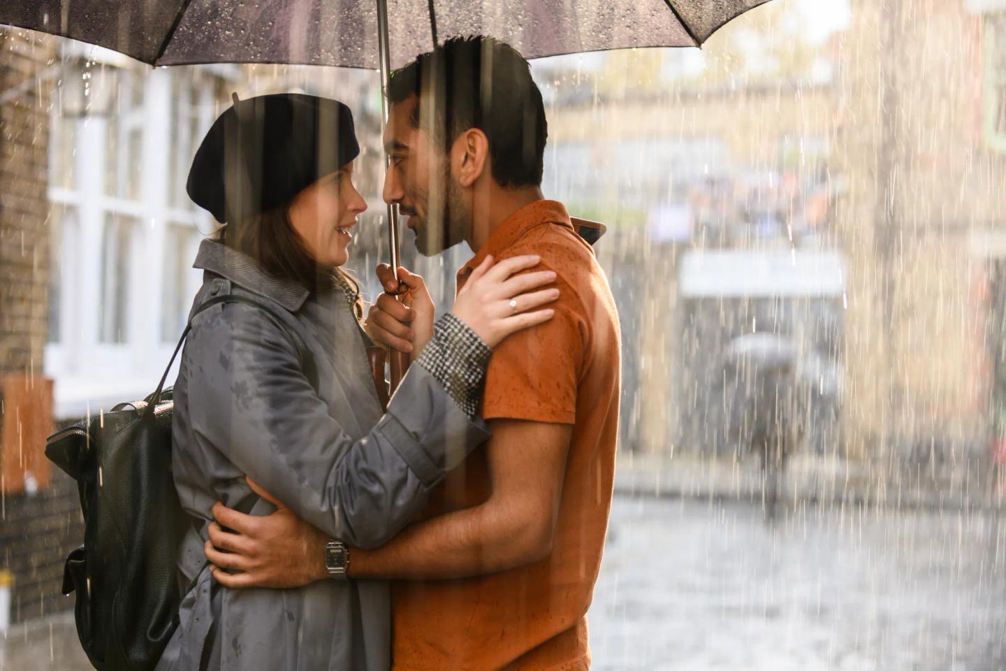 a man and woman holding an umbrella
