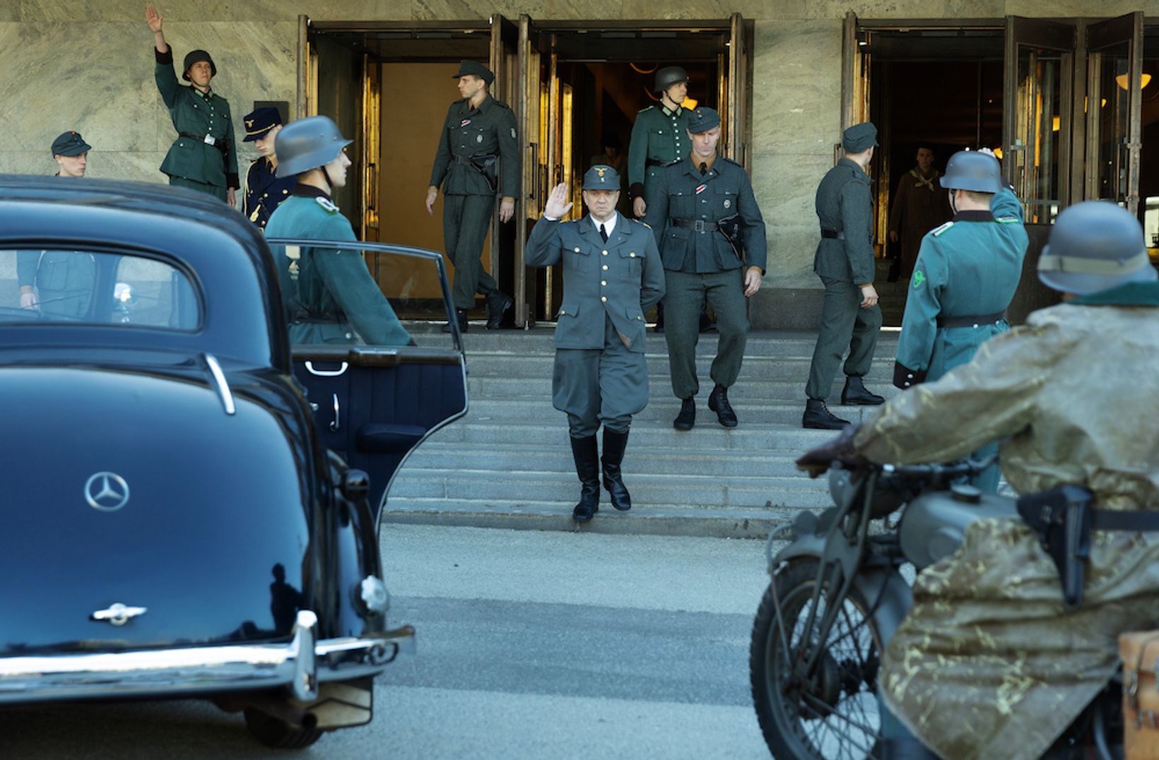 a group of people in uniform walking down a street