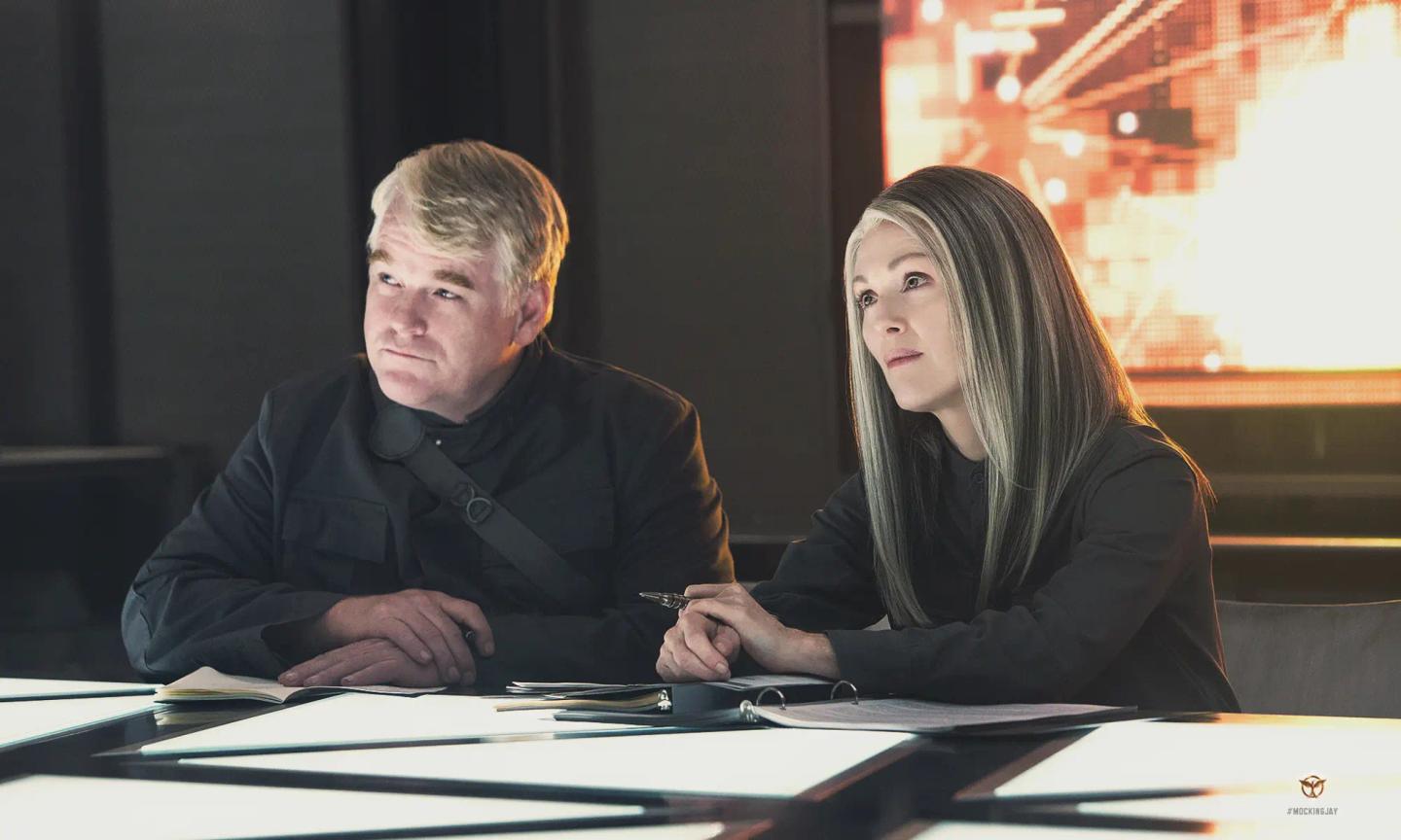 Philip Seymour Hoffman et al. sitting at a table