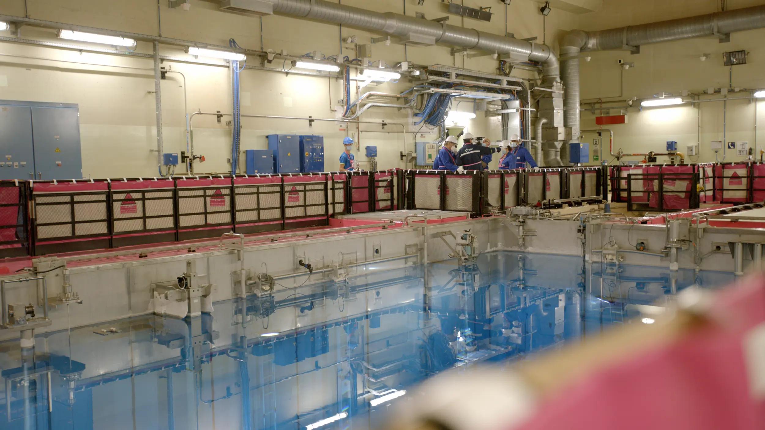 a large room with blue and red containers