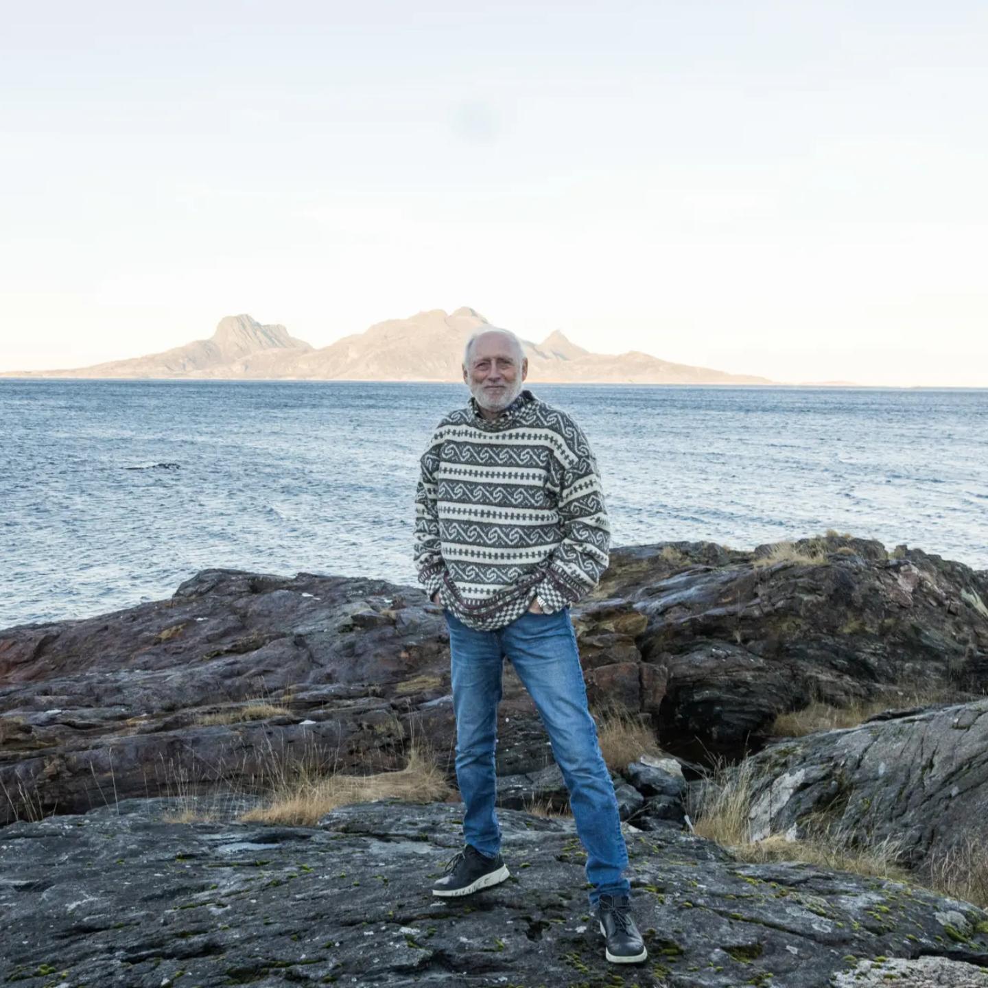 a man standing on a rocky shore