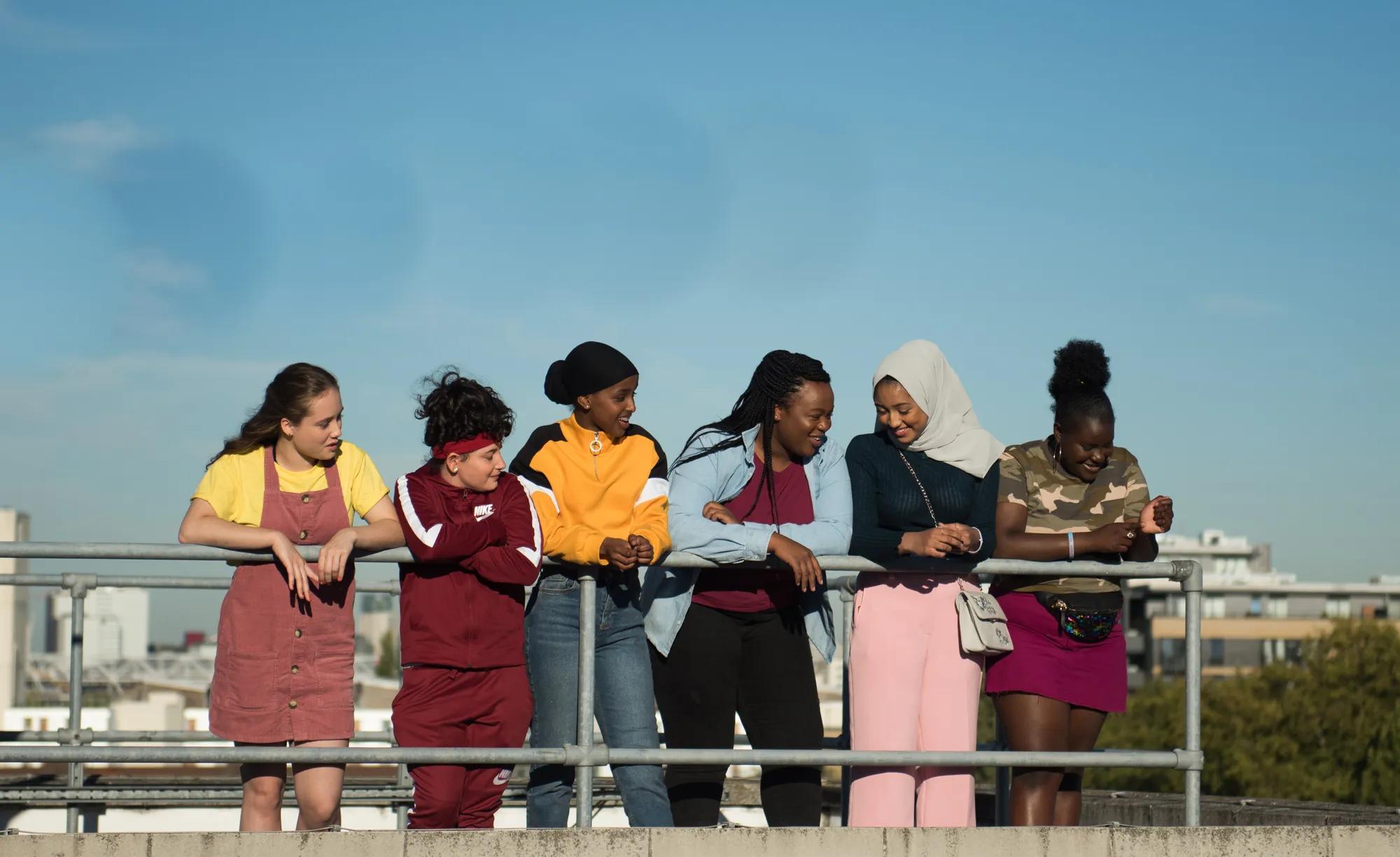 a group of people standing on a bridge