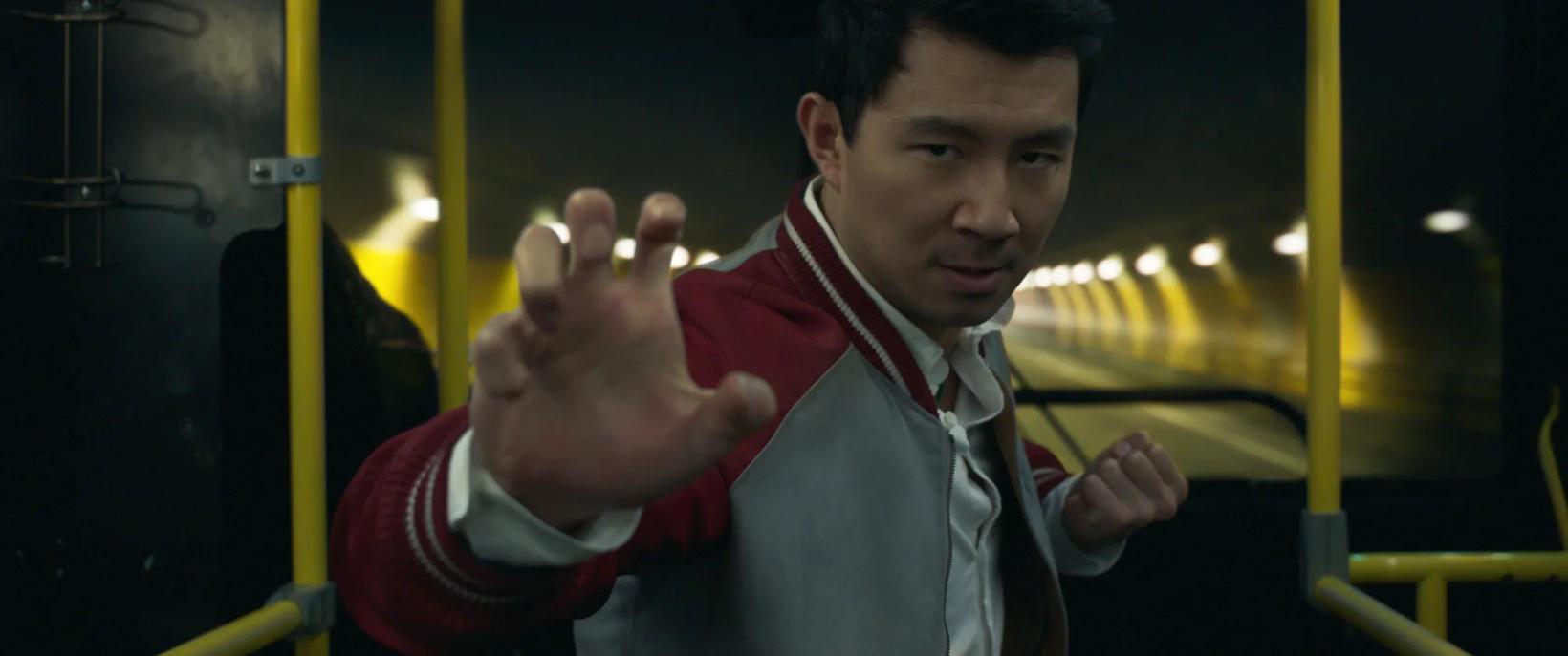Simu Liu holding the hands up
