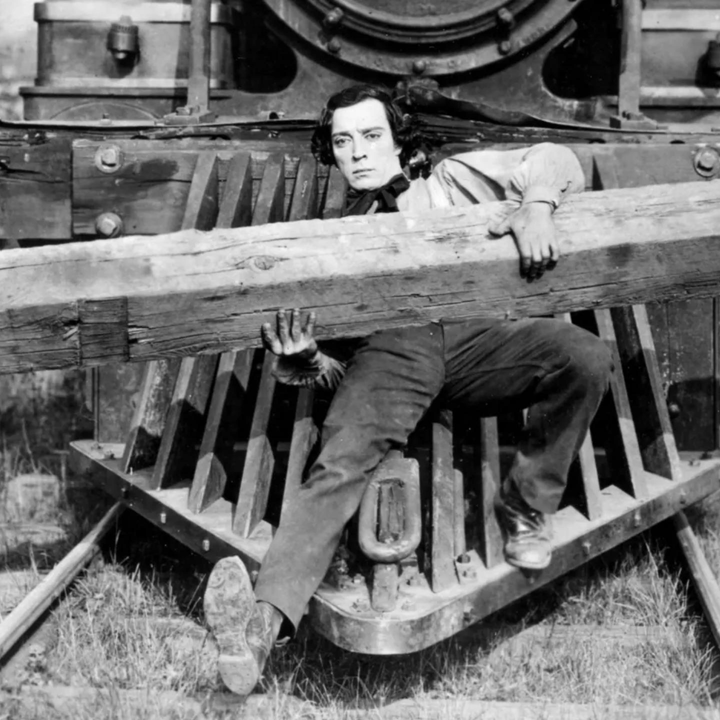Buster Keaton sitting in a wooden wagon