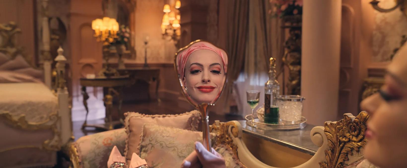Anne Hathaway sitting in a chair