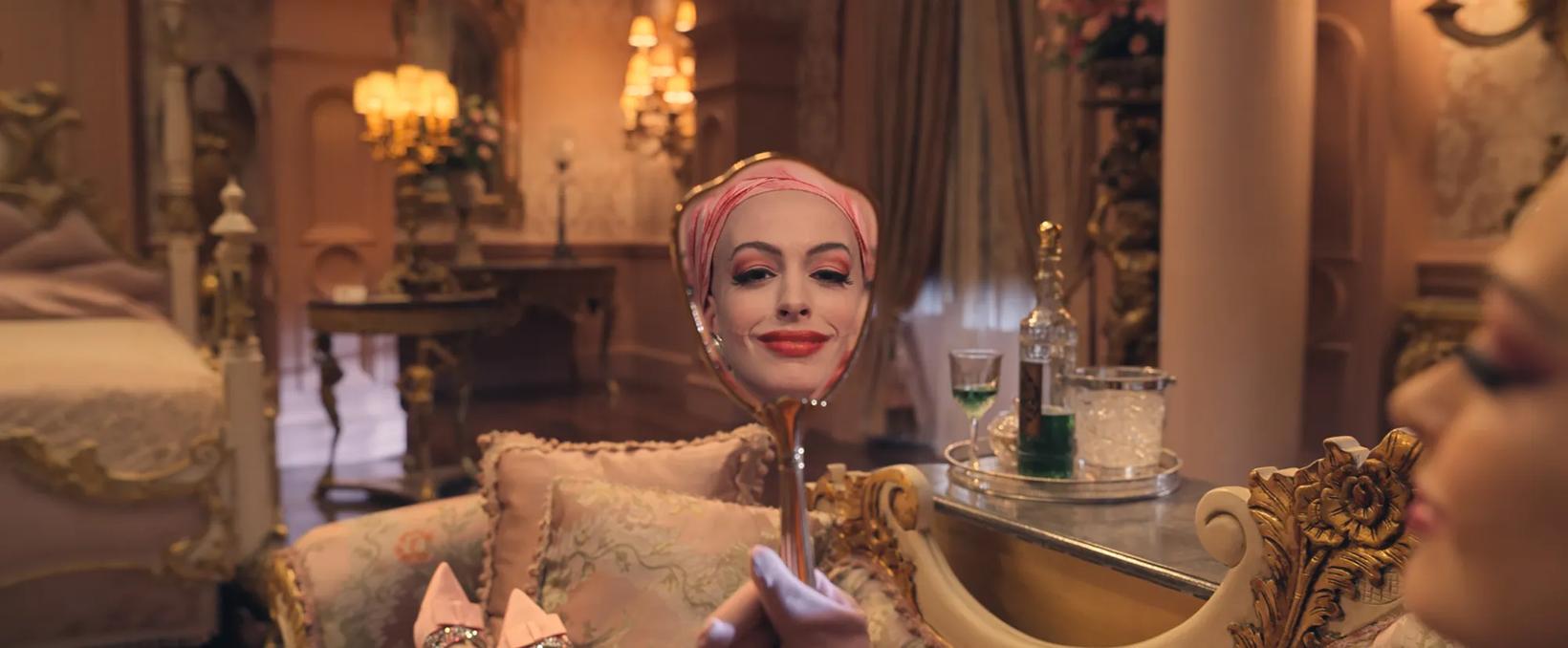 Anne Hathaway sitting in a chair