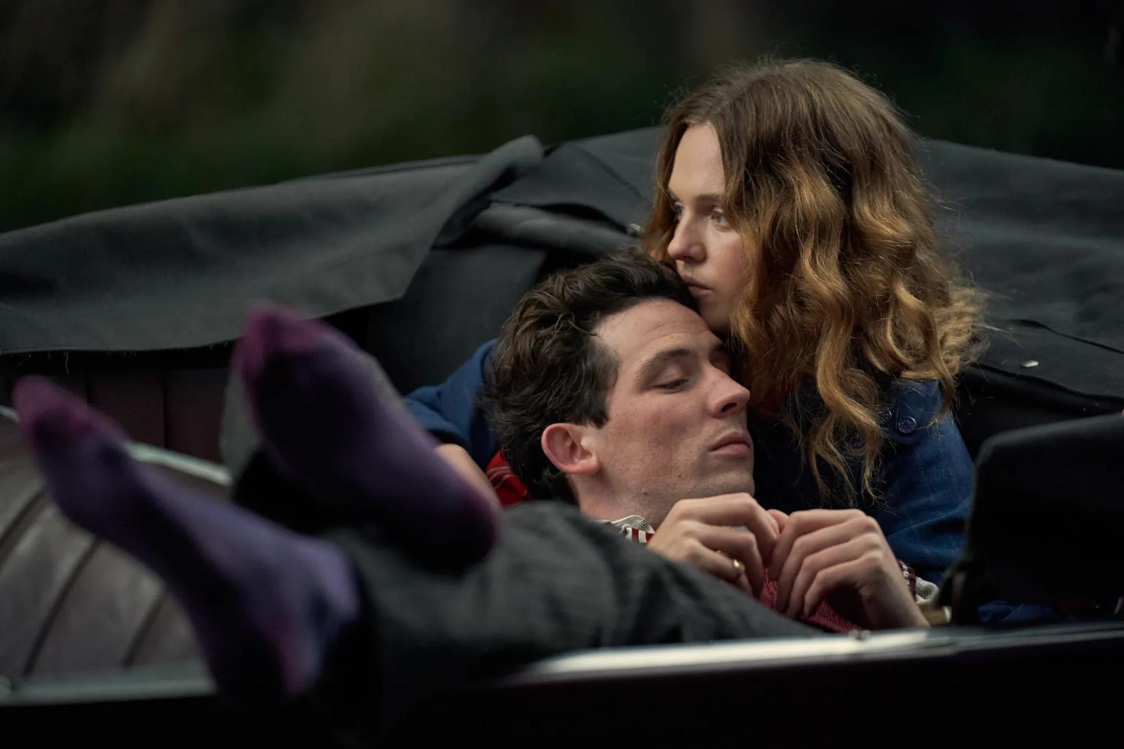 Josh O'Connor and woman sitting in a car