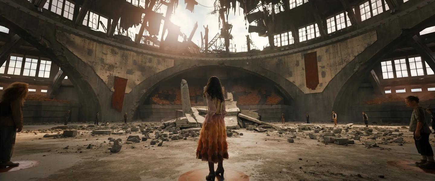 a person in a dress standing in a large room with people