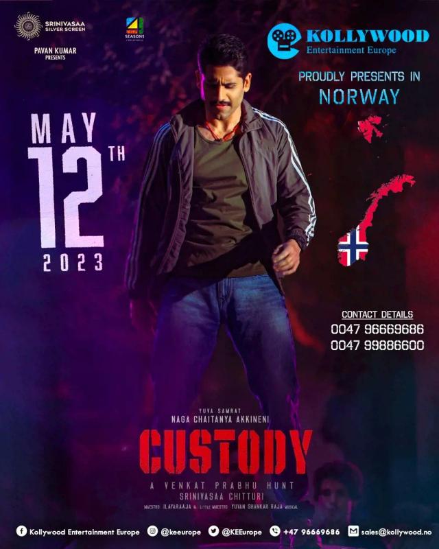 Naga Chaitanya standing in front of a poster