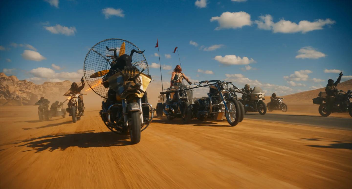 a group of motorcycles on a desert road