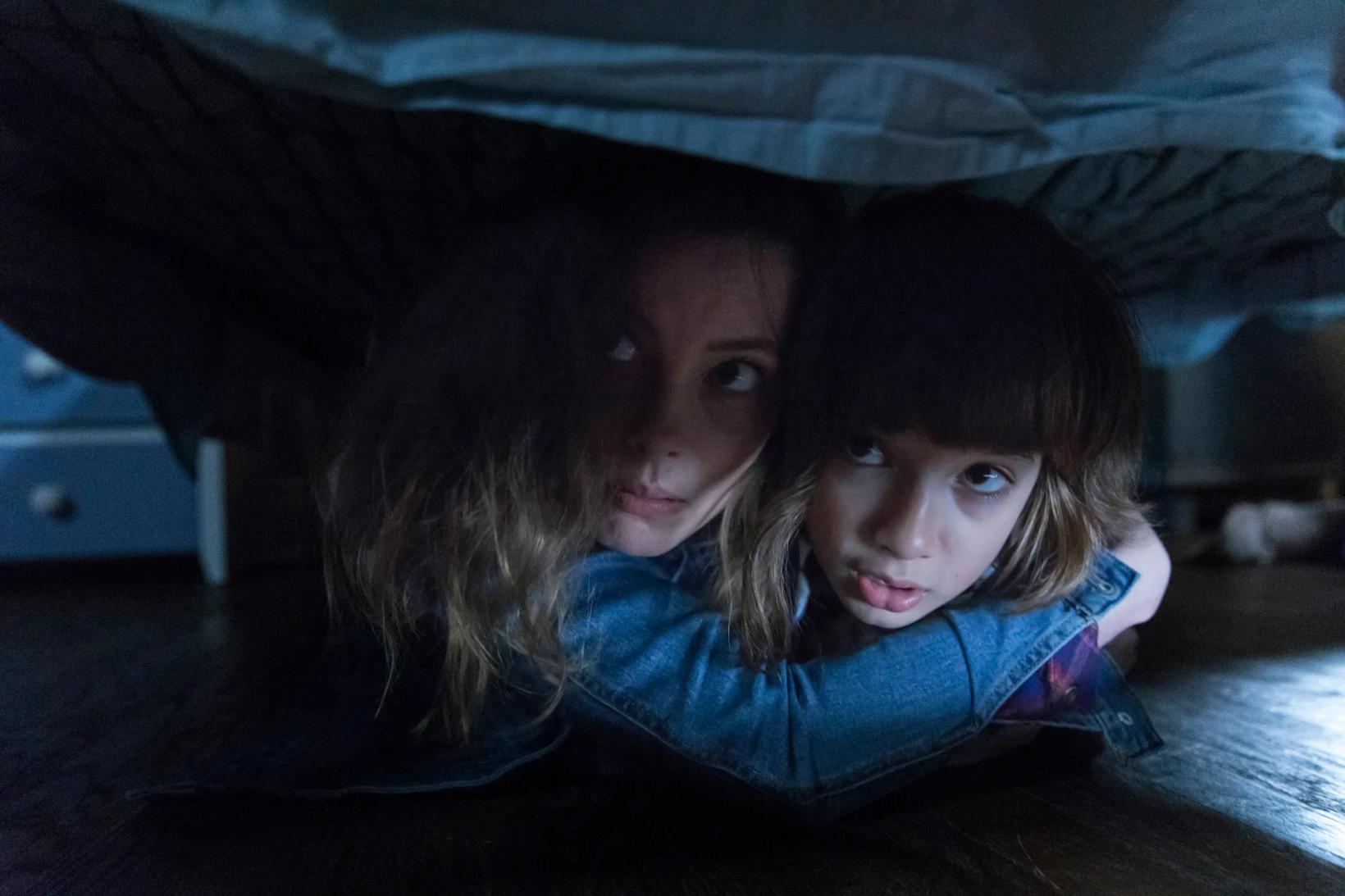 two girls under a black tent
