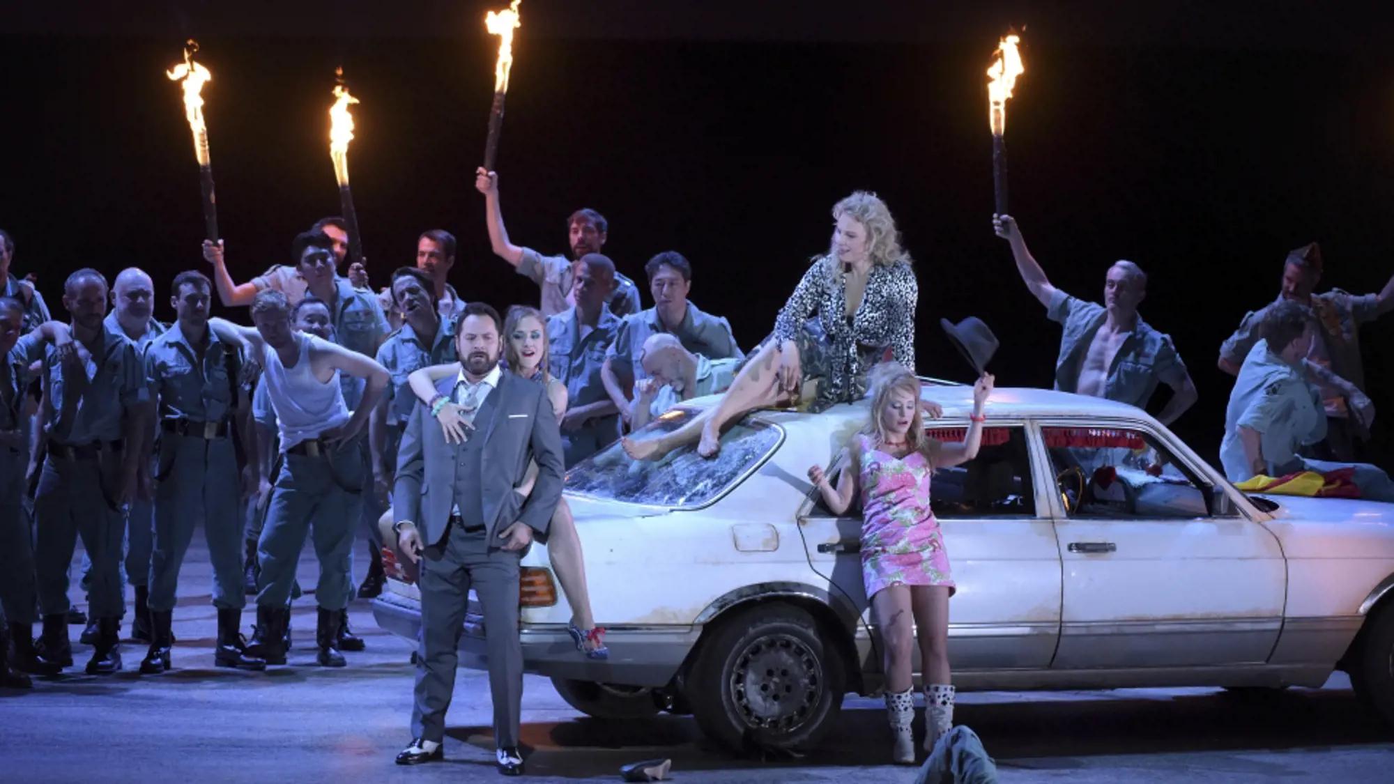 a group of people on a car with people on the roof