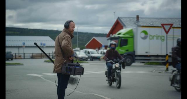 a man on a motorcycle carrying a briefcase