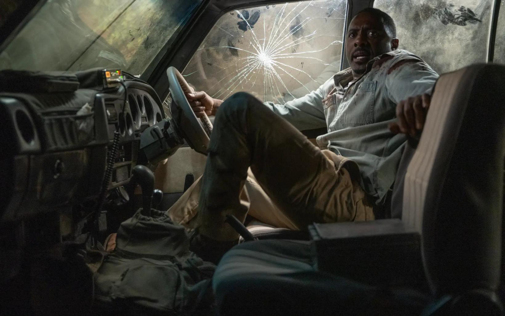 Idris Elba sitting in a car