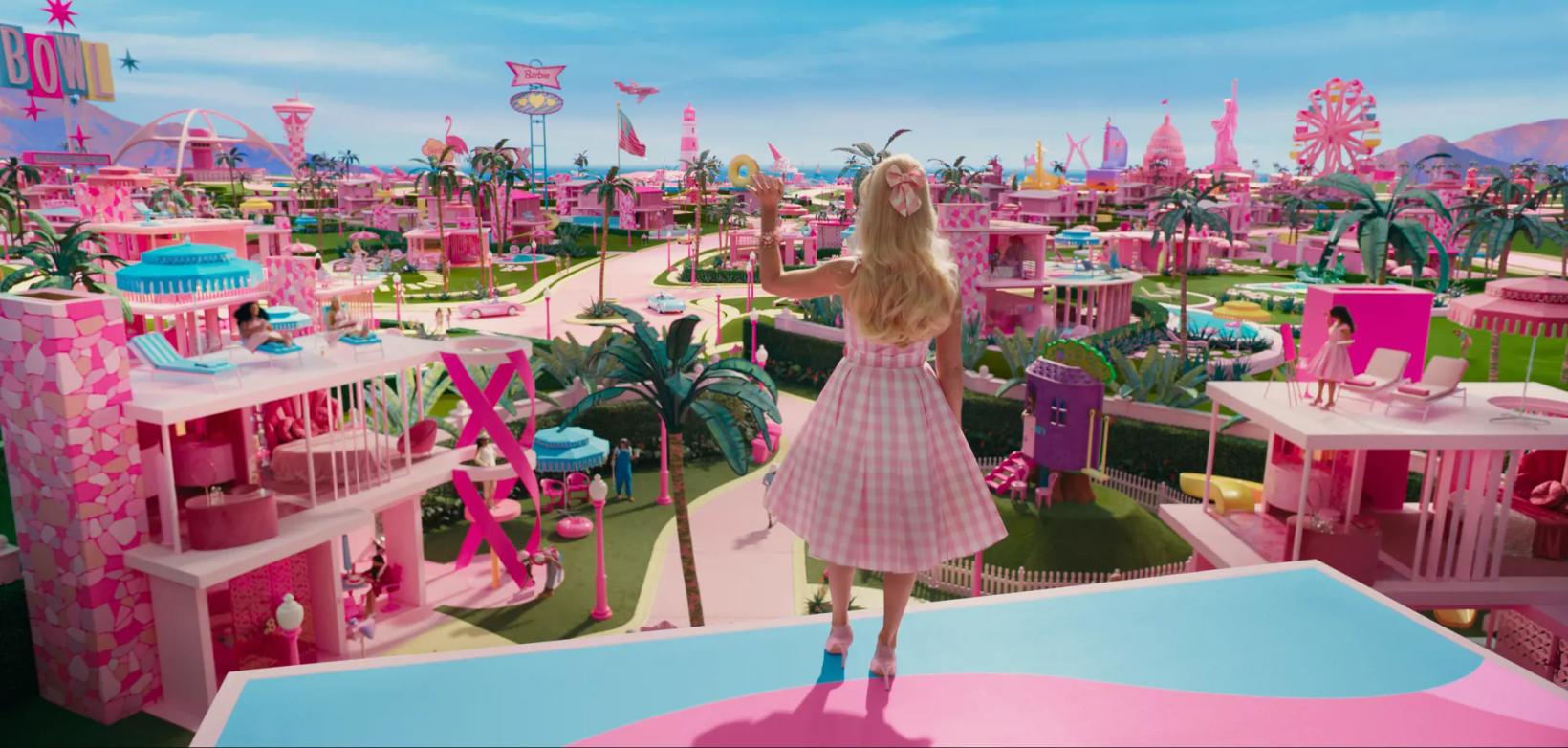 a person standing in front of a colorful amusement park ride