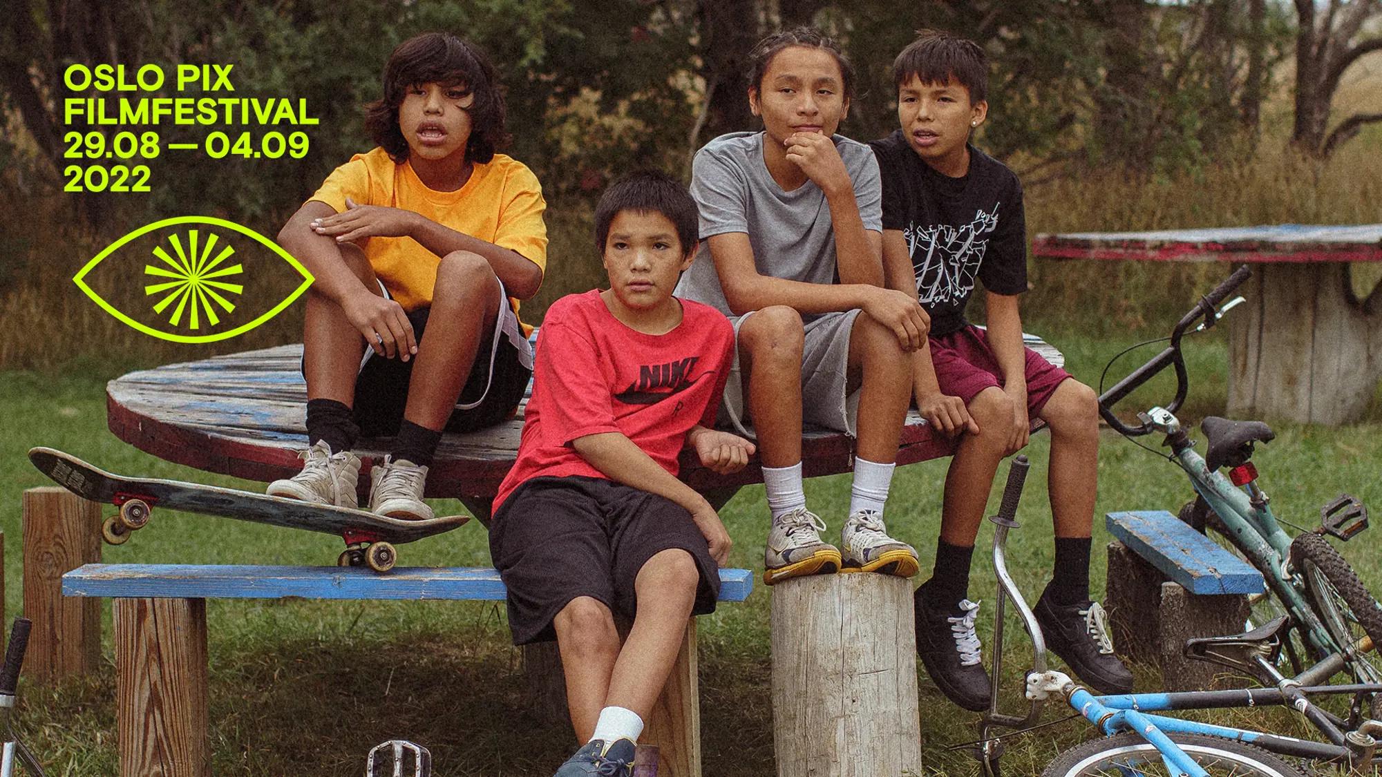 a group of people sitting on a bench posing for the camera