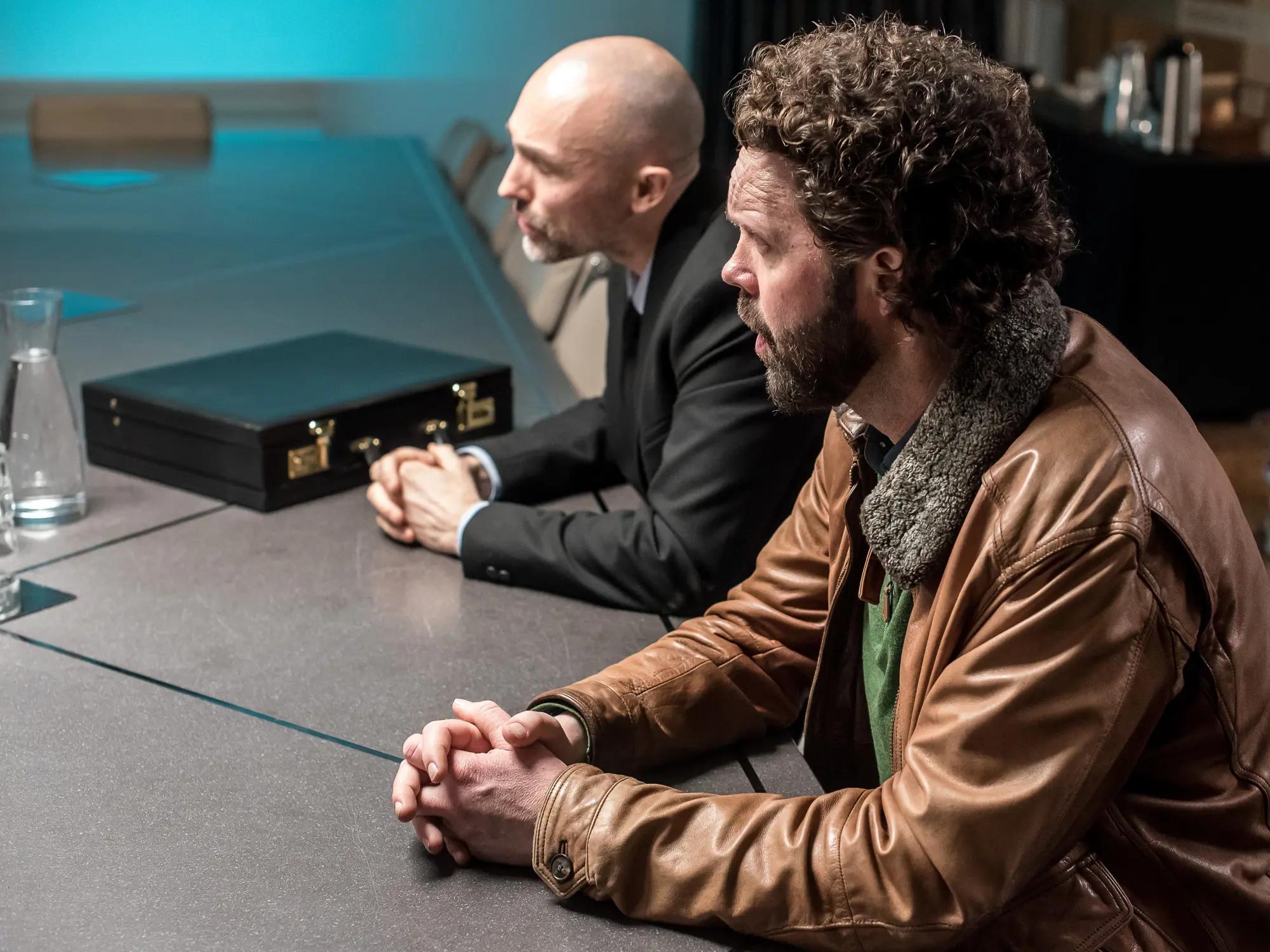 a couple of men sitting at a table