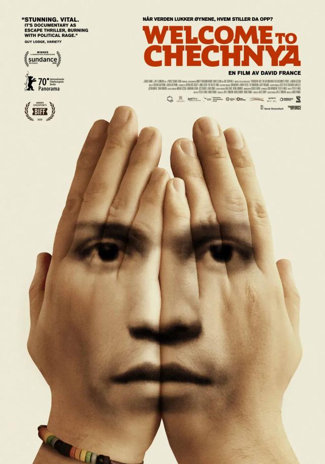 a man with his hand on his face looking at another man