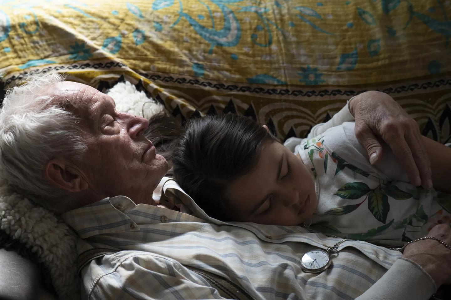 a person and a baby sleeping