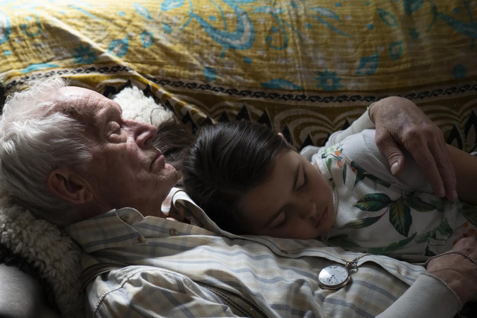a person and a baby sleeping