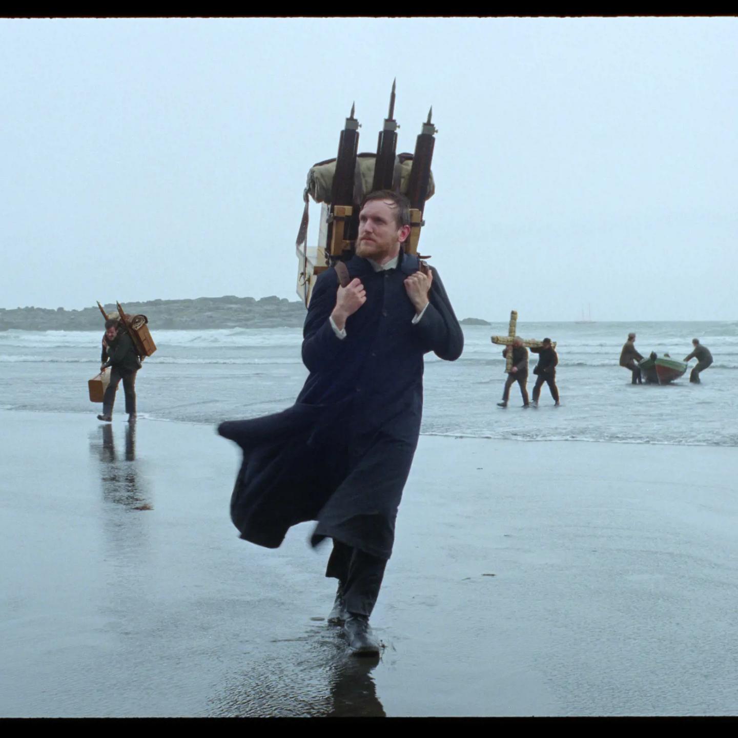 a man wearing a robe and holding a cross on his head