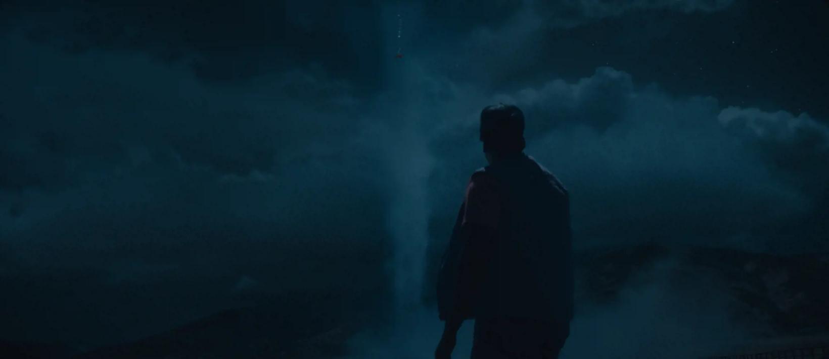 a person looking at a large aquarium