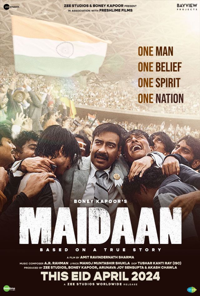 Ajay Devgan with his hands on his head surrounded by people