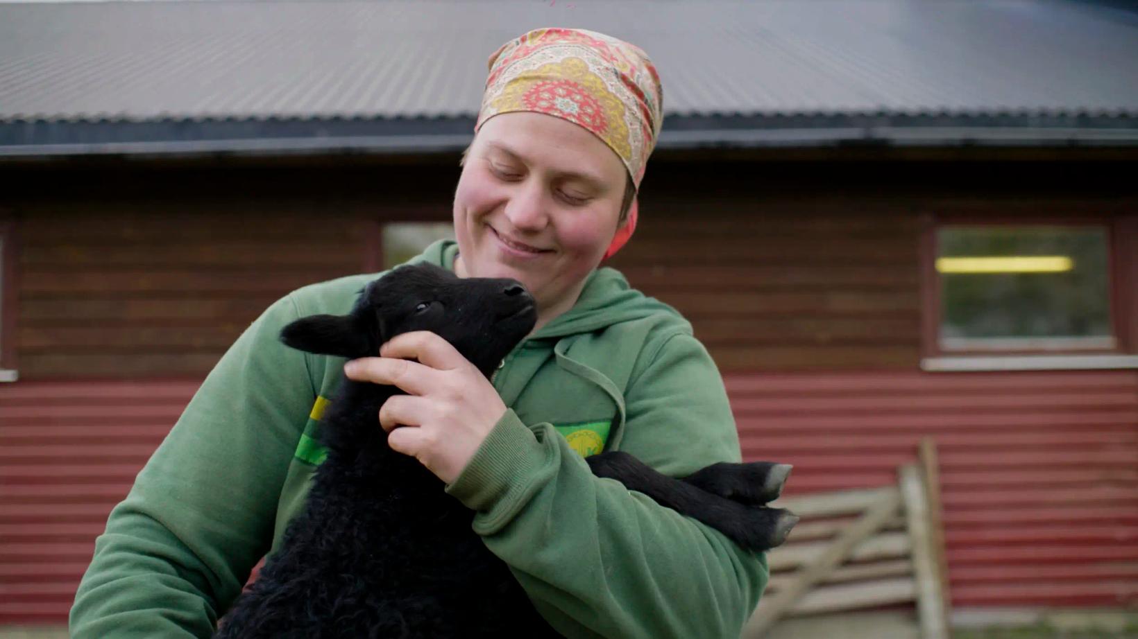 a person holding a black cat