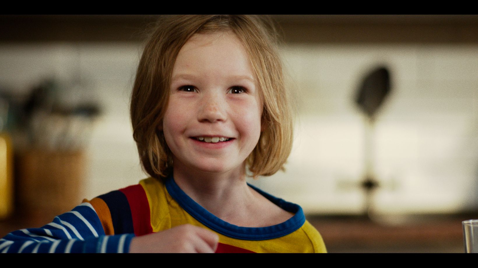 a child smiling at the camera