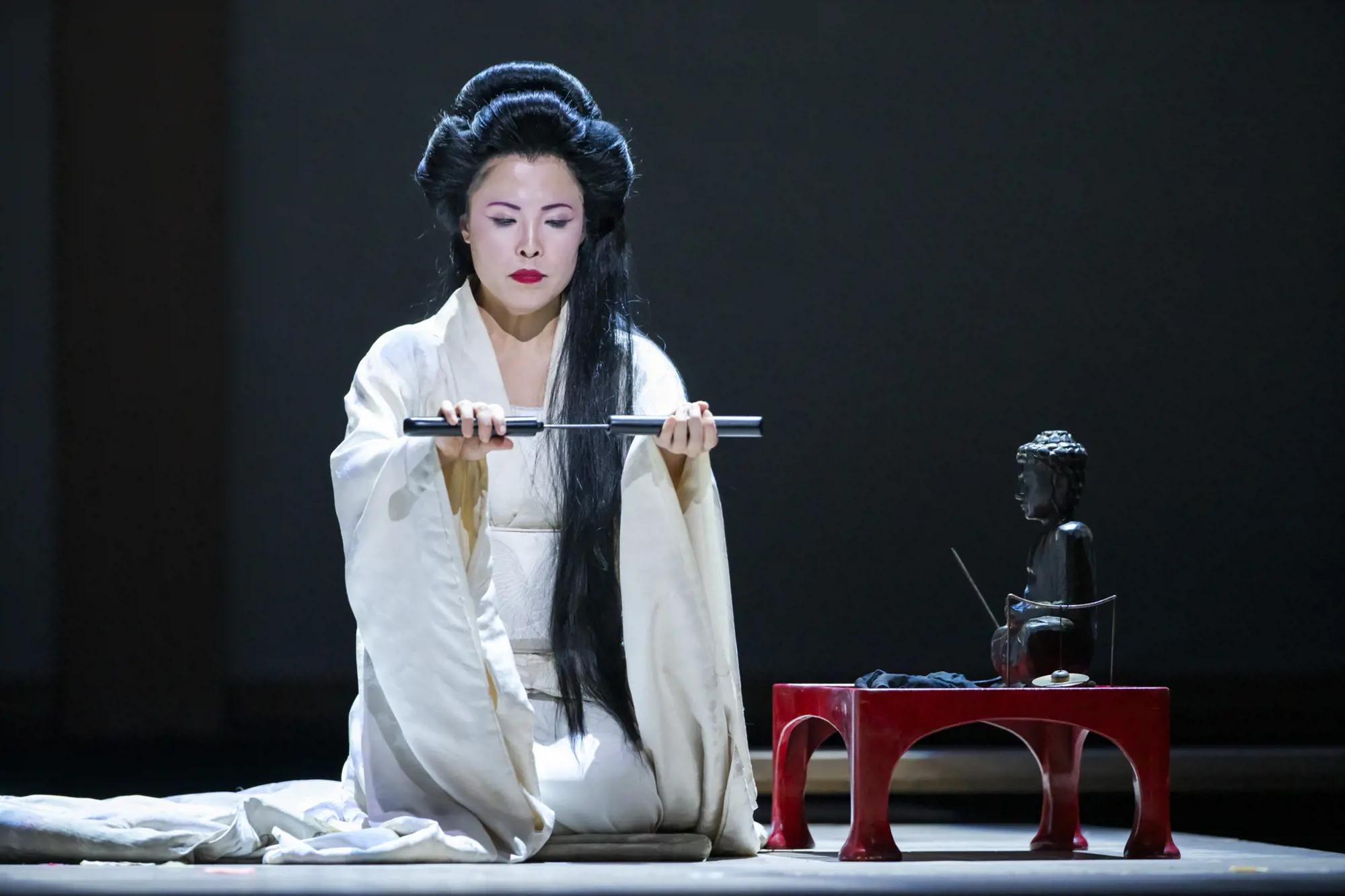 a person wearing a white robe and holding a sword