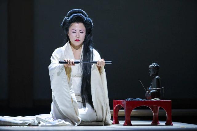 a person wearing a white robe and holding a sword