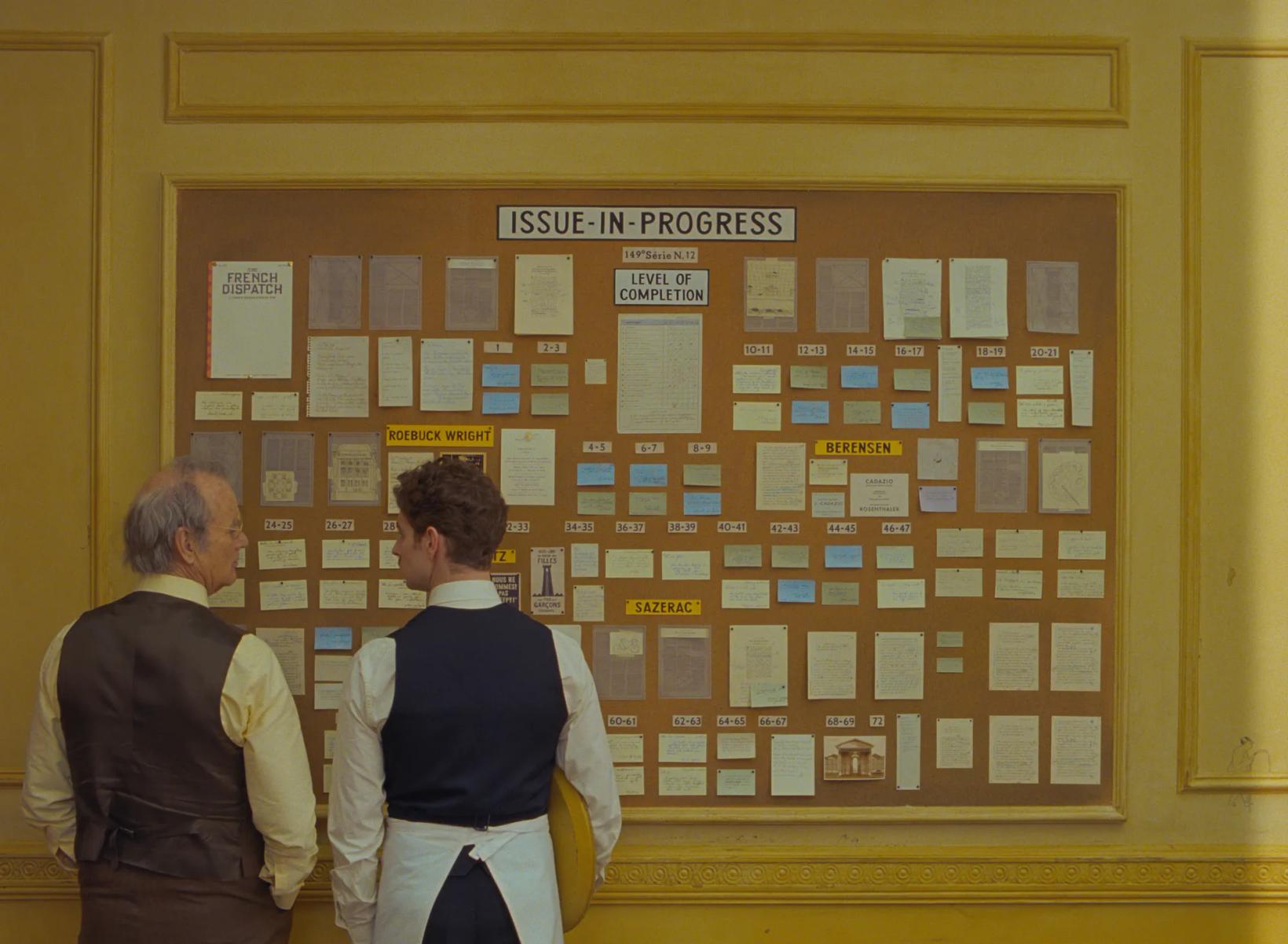 a group of people looking at a board with pictures on it