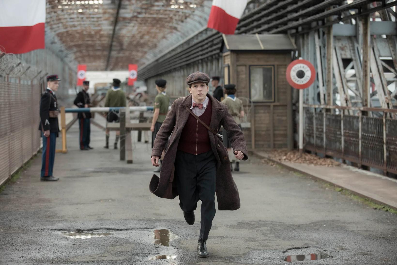 Jesse Eisenberg walking down a street