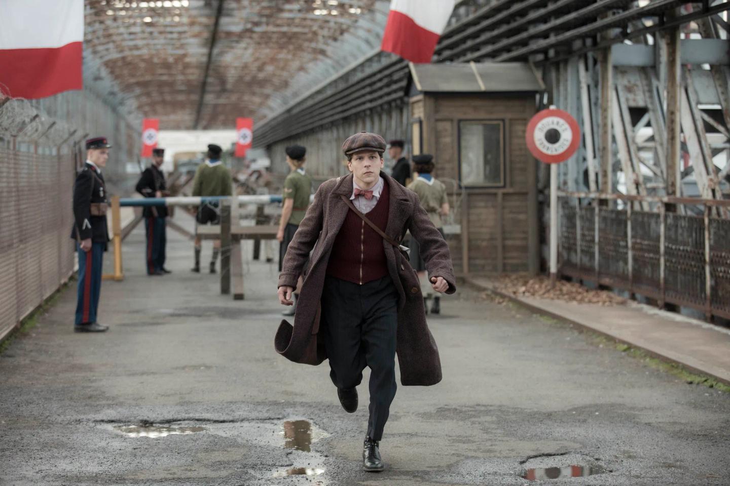 Jesse Eisenberg walking down a street