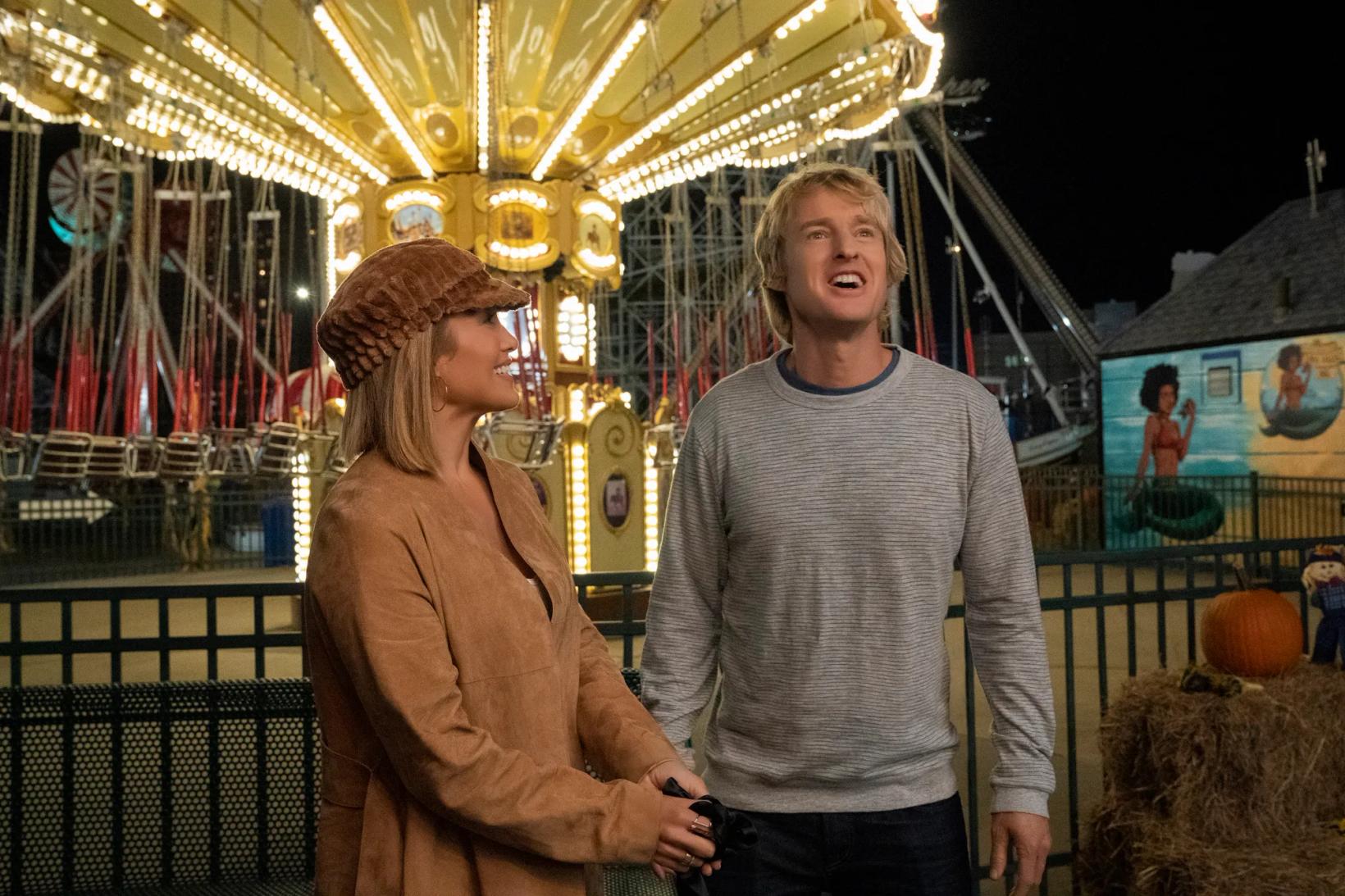 Owen Wilson and woman standing next to each other in a theme park