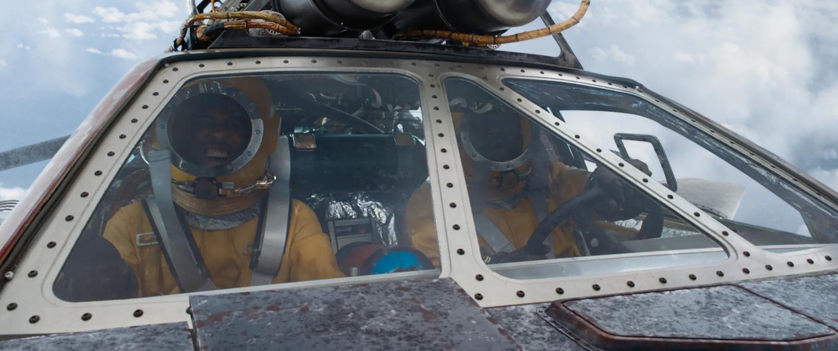 a pilot in a cockpit of a plane