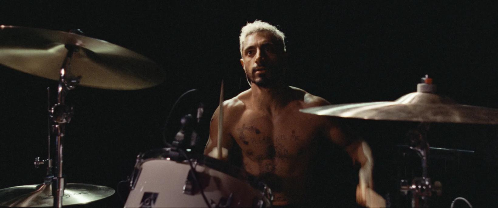Riz Ahmed playing drums