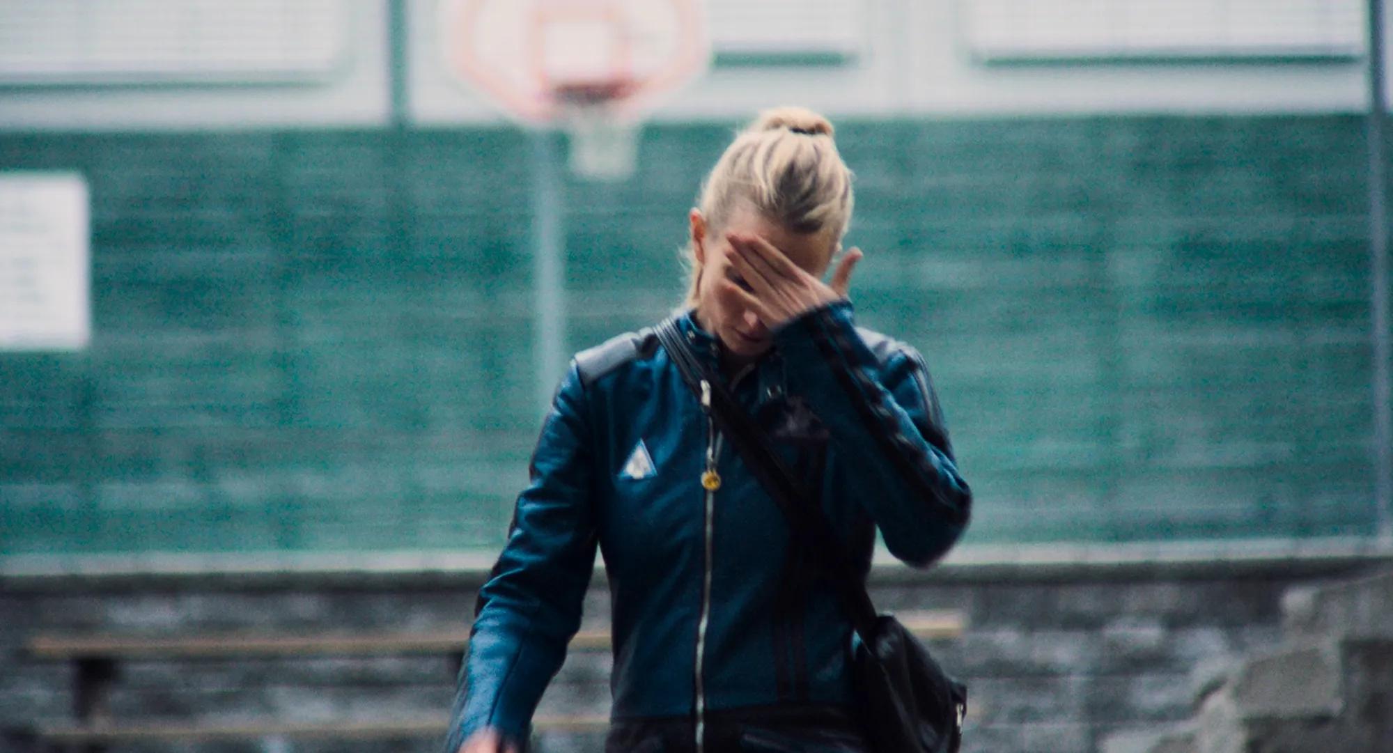a woman with her hand on her face