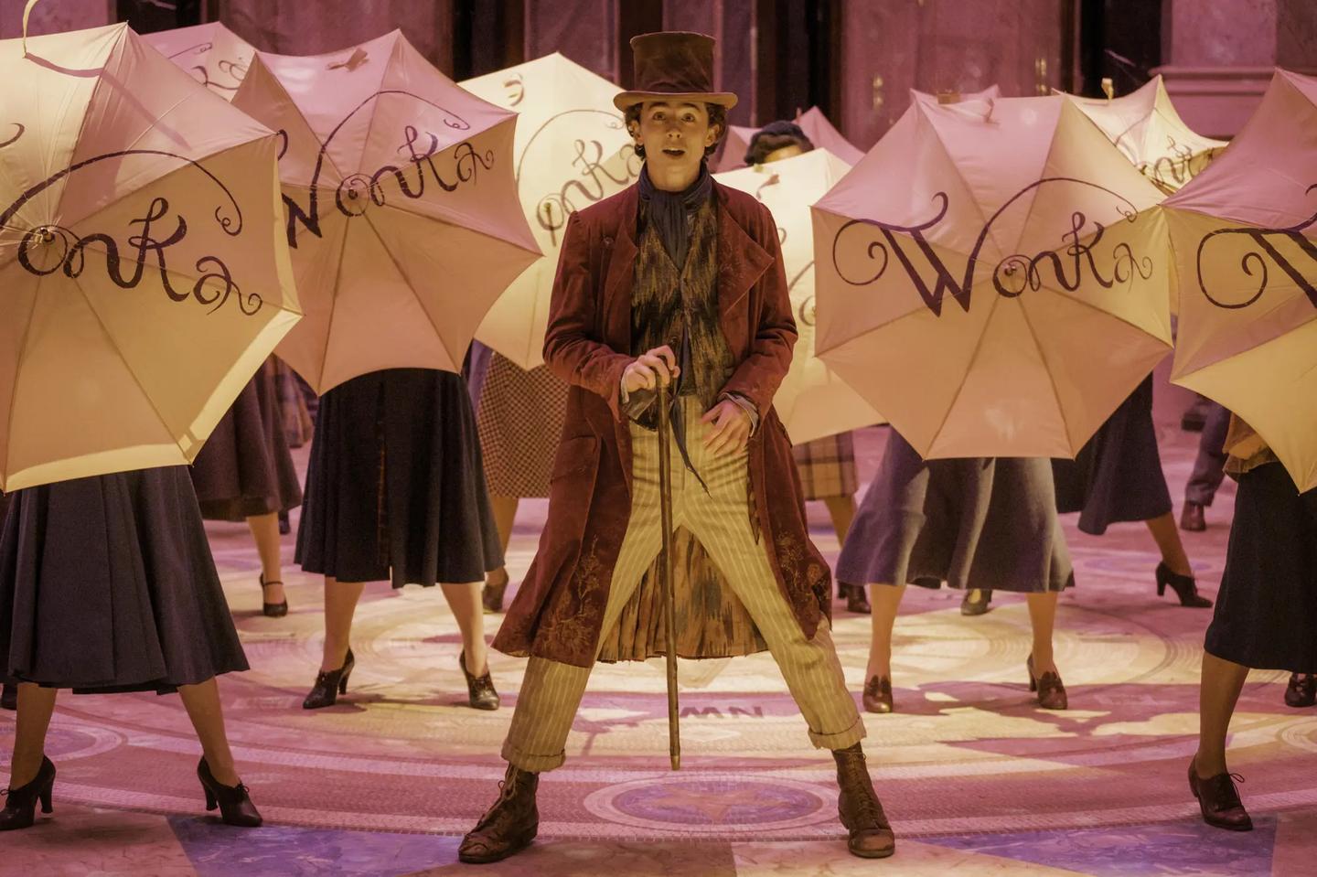 a person in a garment holding an umbrella