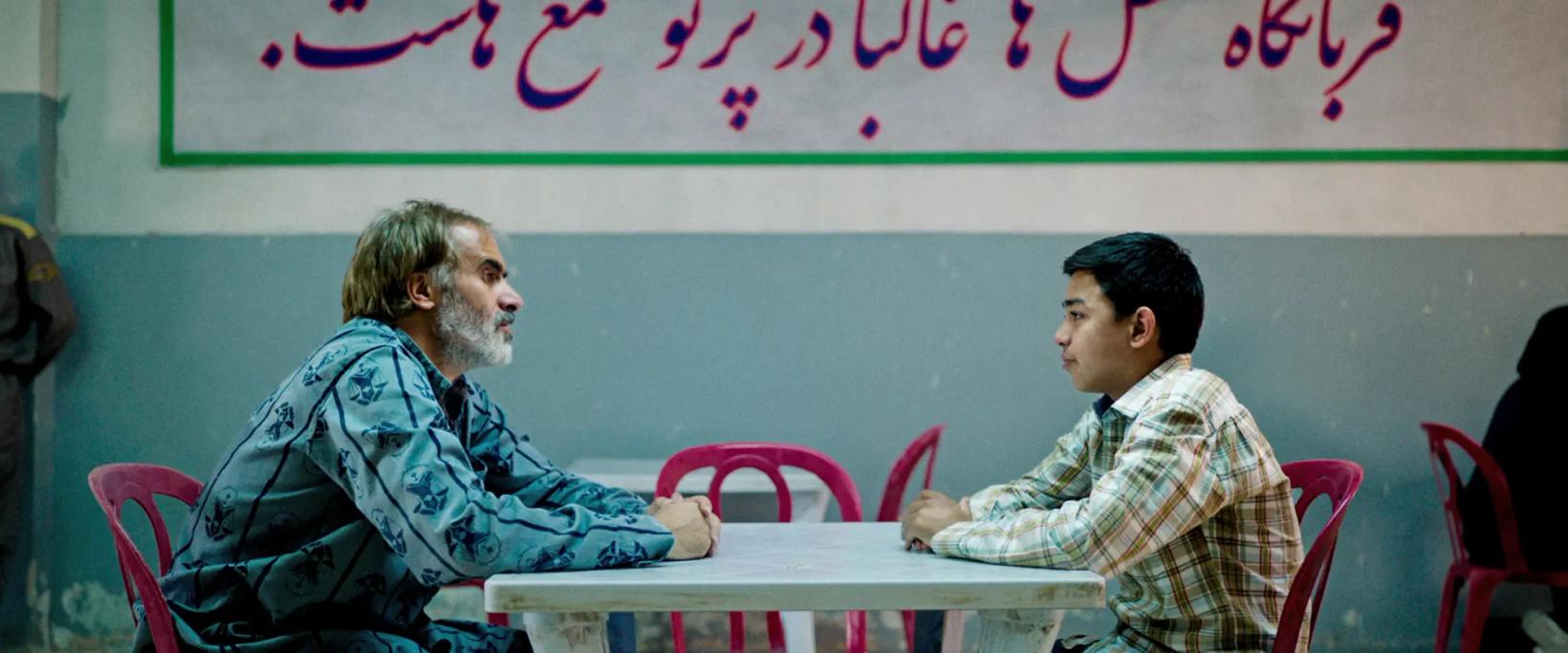 a couple of men sitting at a table