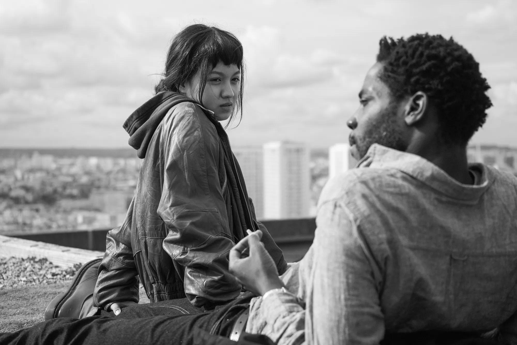 a man and woman sitting on a bench