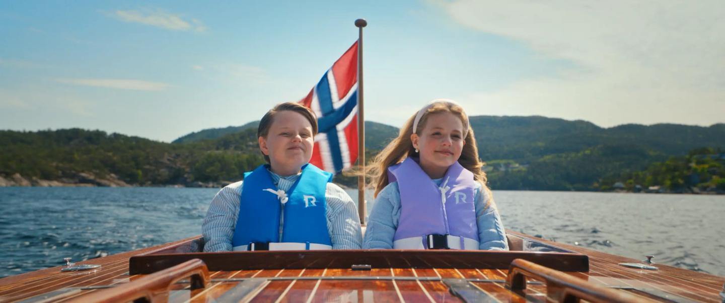 a man and a woman on a boat with a flag