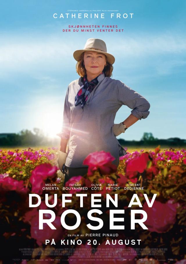Catherine Frot et al. standing in a field of flowers