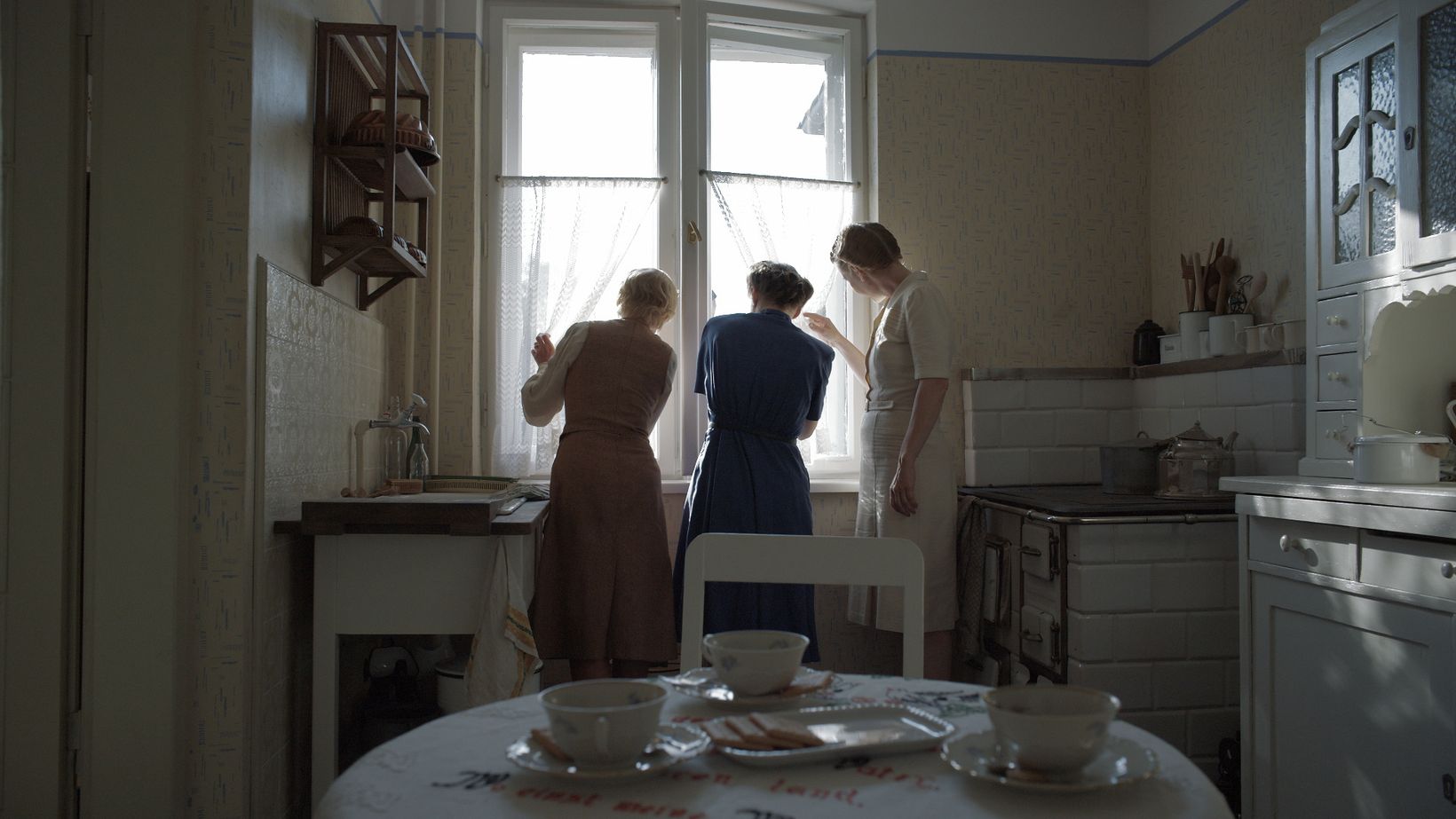 a group of people in a kitchen