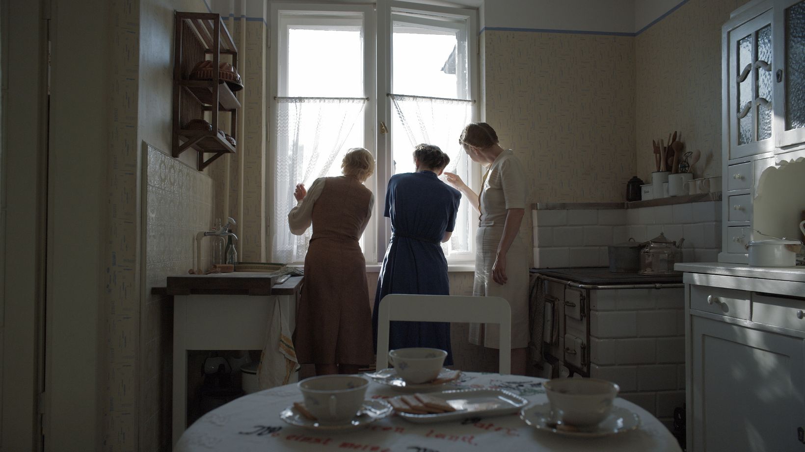 a group of people in a kitchen