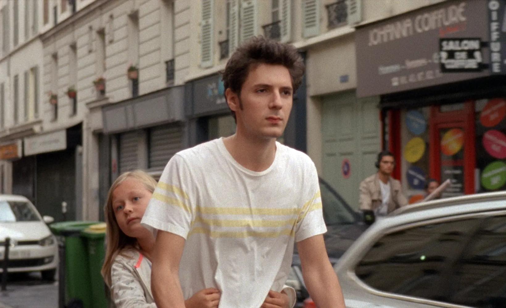 Vincent Lacoste et al. standing in front of a building